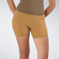 Shorts in apricot brown on model - Flow State Collection activewear