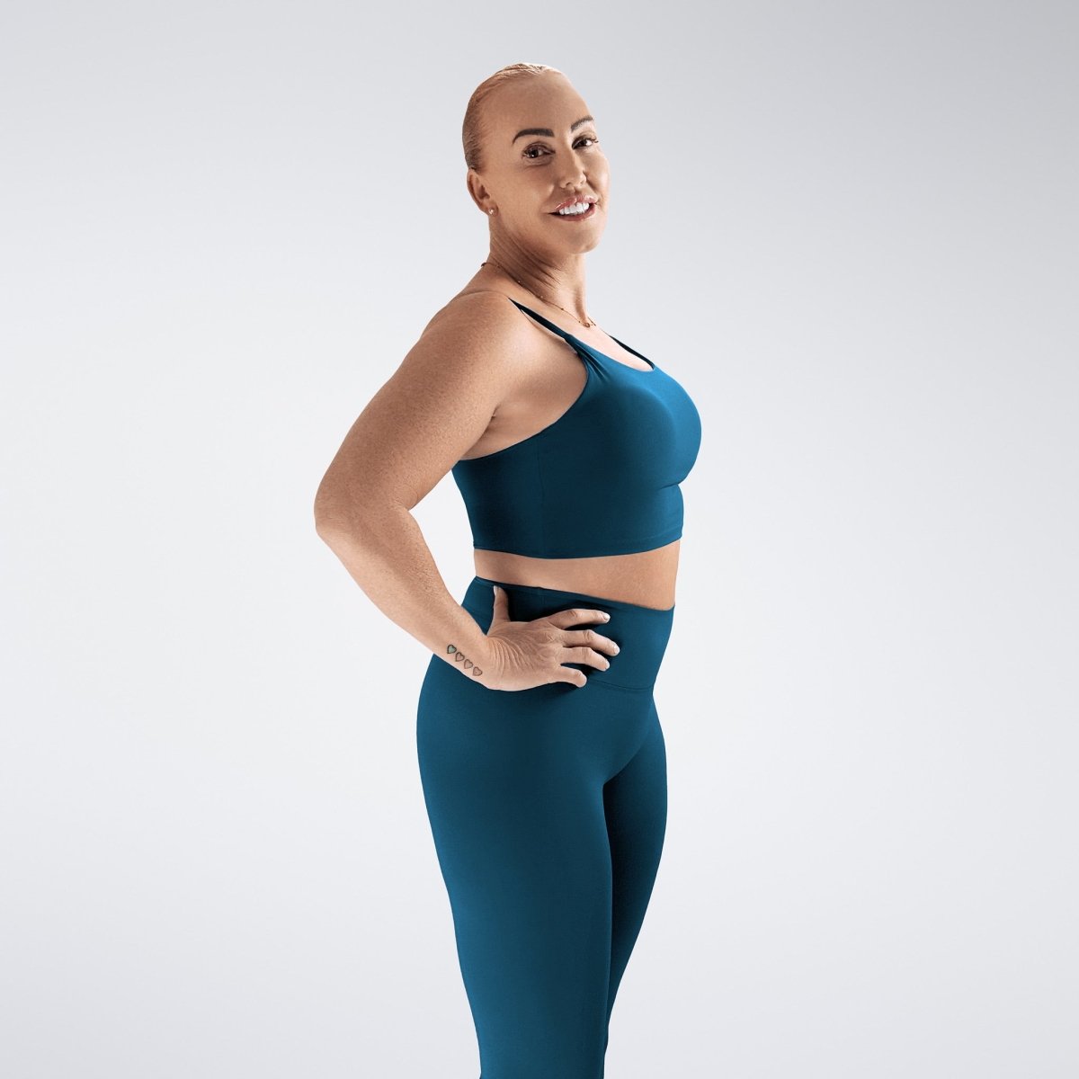 Sports Bra in peacock green on model - Flow State activewear
