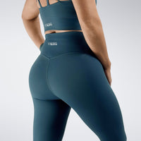 Leggings in peacock green on model - Flow State activewear