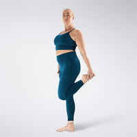 Leggings in peacock green on model - Flow State activewear