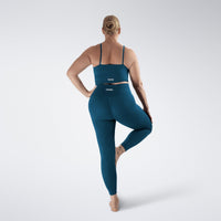 Leggings in peacock green on model - Flow State activewear