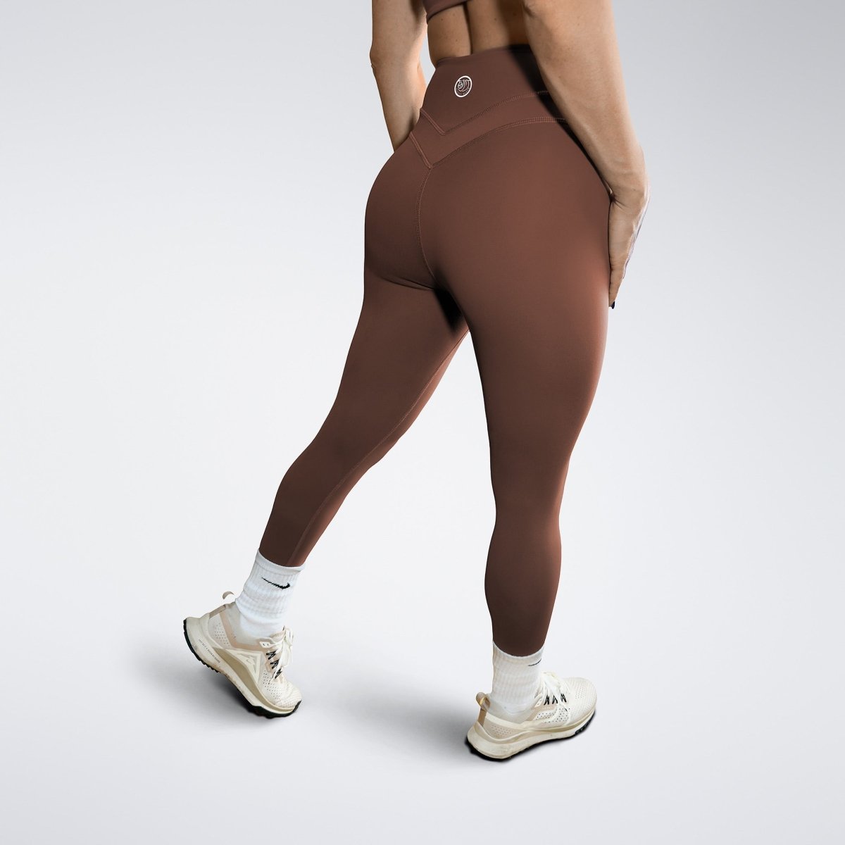 Leggings in chocolate brown on model - Halo Collection activewear