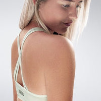 Cross Back Yoga Bra in white on model - Rise Collection activewear