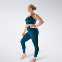 Leggings in peacock green on model - Flow State activewear