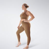 Leggings in apricot brown on model - Flow State activewear