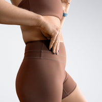 Shorts in chocolate brown on model - Halo Collection activewear