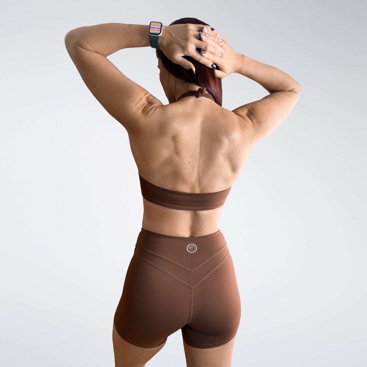 Shorts in chocolate brown on model - Halo Collection activewear