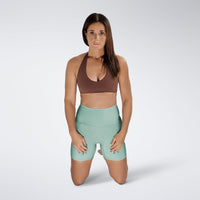 Shorts in mint green on model - Surge Collection activewear