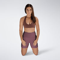Shorts in burgundy on model - Surge Collection activewear