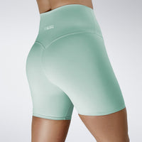Shorts in mint green on model - Surge Collection activewear